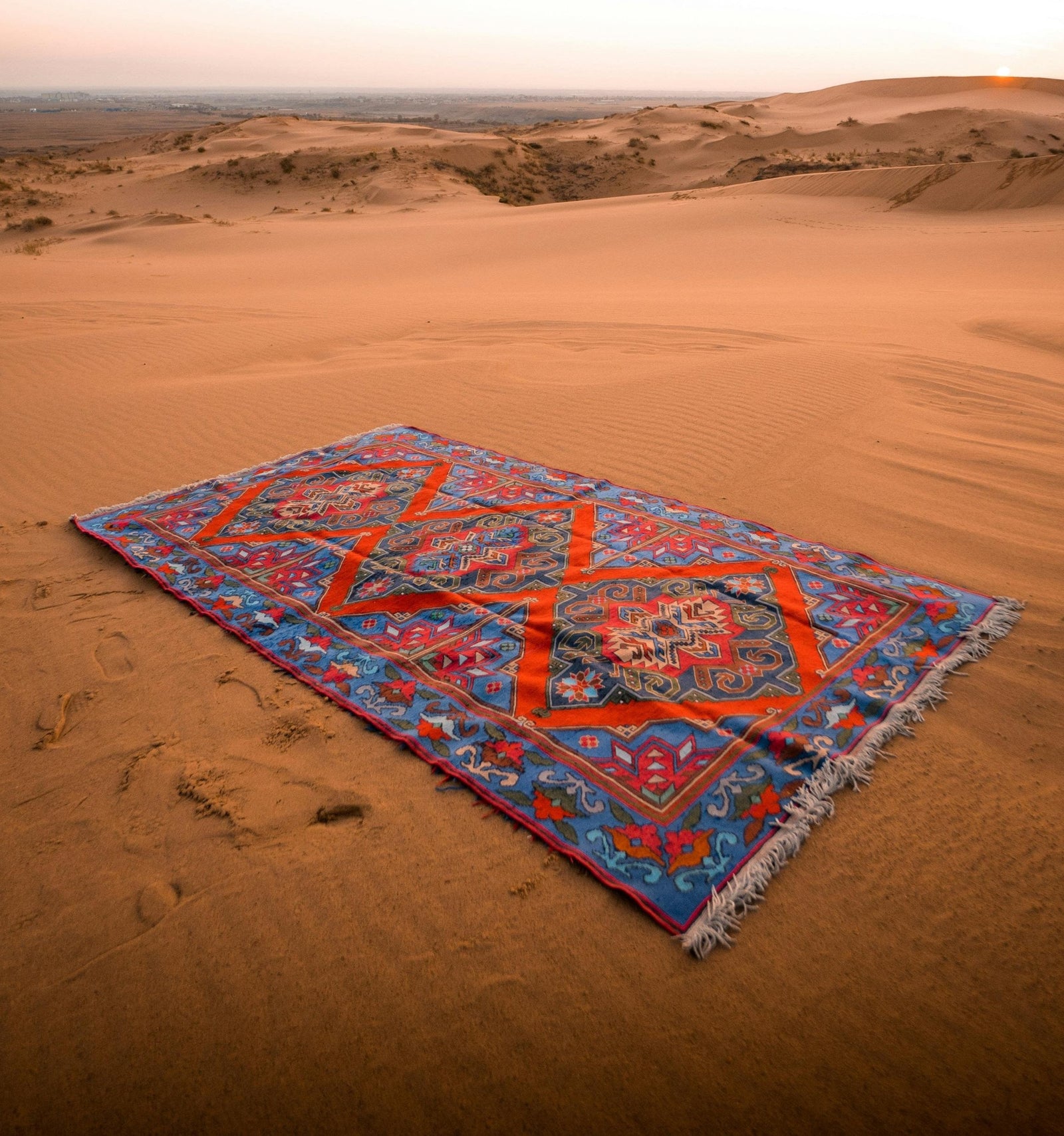 Blue and Red Handmade rug in a desert 