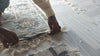 Rug Artisan Trimming a handmade rug